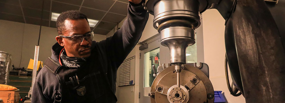 Machinist at work inside NSWC Corona Measurement Science and Technology Lab (MSTL)